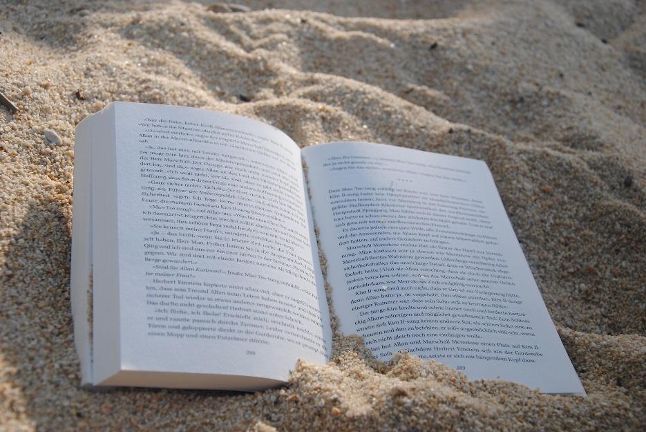 A book placed in sand